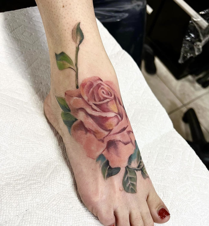 Color realism rose foot tattoo by Austina Obscure