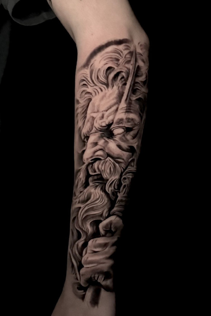 Black and grey Zeus forearm tattoo by Austina Obscure