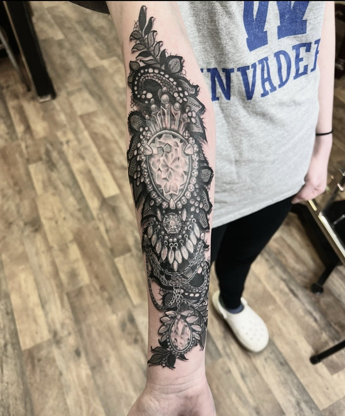 Black and grey jewel and lace forearm tattoo by Austina Obscure